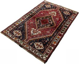 Corner detail of 2000s Shiraz rug showing border pattern and Wool pile