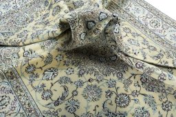 Surface texture of 2000s Nain rug with natural Wool and intricate pattern