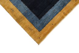 Backside of handmade New Persian Gabbeh rug showing knot structure and weave density