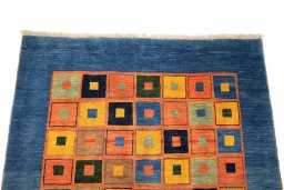 Surface texture of 2000s Persian Gabbeh rug with natural Wool and intricate pattern
