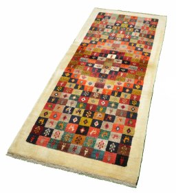 Corner detail of 2000s Persian Gabbeh rug showing border pattern and Wool pile