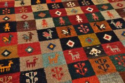 Surface texture of 2000s Persian Gabbeh rug with natural Wool and intricate pattern