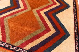 Backside of handmade 2000s Persian Gabbeh rug showing knot structure and weave density