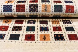 Corner detail of 2000s Persian Gabbeh rug showing border pattern and Wool pile