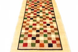 Surface texture of 2000s Persian Gabbeh rug with natural Wool and intricate pattern
