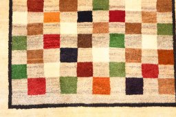Backside of handmade 2000s Persian Gabbeh rug showing knot structure and weave density