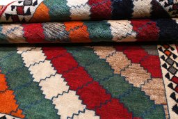 Corner detail of 2000s Persian Gabbeh rug showing border pattern and Wool pile