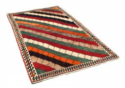 Corner detail of 2000s Persian Gabbeh rug showing border pattern and Wool pile