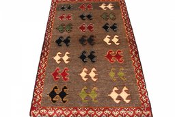 Surface texture of 2000s Persian Gabbeh rug with natural Wool and intricate pattern
