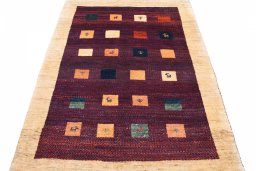 Surface texture of 2000s Persian Gabbeh rug with natural Wool and intricate pattern