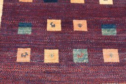 Backside of handmade 2000s Persian Gabbeh rug showing knot structure and weave density