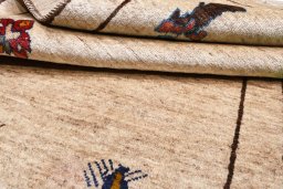Corner detail of 2000s Persian Gabbeh rug showing border pattern and Wool pile