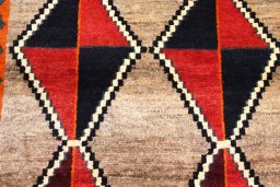 Backside of handmade 2000s Persian Gabbeh rug showing knot structure and weave density