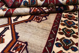 Corner detail of 2000s Persian Gabbeh rug showing border pattern and Wool pile