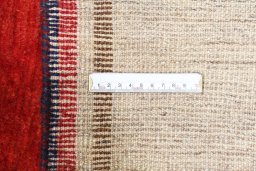 Surface texture of 2000s Persian Gabbeh rug with natural Wool and intricate pattern