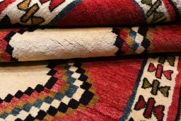 Corner detail of 2000s Persian Gabbeh rug showing border pattern and Wool pile
