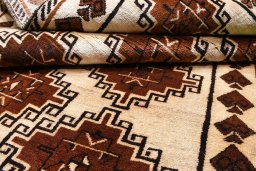 Corner detail of 2000s Persian Gabbeh rug showing border pattern and Wool pile