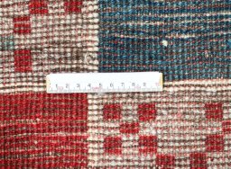 Corner detail of 2000s Persian Gabbeh rug showing border pattern and Wool pile