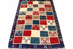 Surface texture of 2000s Persian Gabbeh rug with natural Wool and intricate pattern