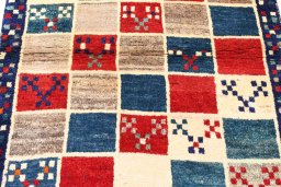 Backside of handmade 2000s Persian Gabbeh rug showing knot structure and weave density