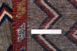 Corner detail of 2000s Persian Gabbeh rug showing border pattern and Wool pile