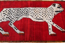 Full view of 2000s Persian Gabbeh rug from Iran / Persia, 227 × 131 cm in Red tones
