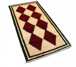 Corner detail of 2000s Persian Gabbeh rug showing border pattern and Wool pile