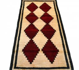 Surface texture of 2000s Persian Gabbeh rug with natural Wool and intricate pattern