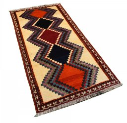 Corner detail of 2000s Persian Gabbeh rug showing border pattern and Wool pile