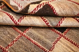Corner detail of 2000s Persian Gabbeh rug showing border pattern and Wool pile