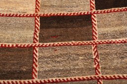 Backside of handmade 2000s Persian Gabbeh rug showing knot structure and weave density