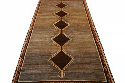 Surface texture of 2000s Persian Gabbeh rug with natural Wool and intricate pattern