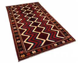 Corner detail of 2000s Persian Gabbeh rug showing border pattern and Wool pile