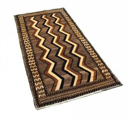Corner detail of 2000s Persian Gabbeh rug showing border pattern and Wool pile