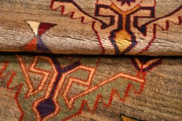 Corner detail of 2000s Persian Gabbeh rug showing border pattern and Wool pile