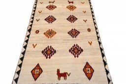 Surface texture of 2000s Persian Gabbeh rug with natural Wool and intricate pattern