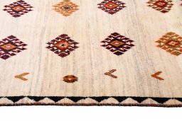 Full view of 2000s Persian Gabbeh rug from Iran / Persia, 175 × 115 cm in Beige tones