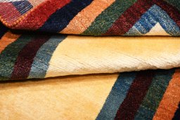 Corner detail of 2000s Persian Gabbeh rug showing border pattern and Wool pile