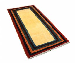 Corner detail of 2000s Persian Gabbeh rug showing border pattern and Wool pile