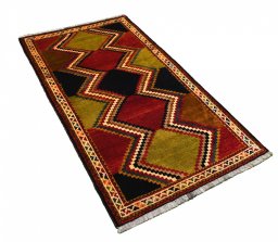 Corner detail of 2000s Persian Gabbeh rug showing border pattern and Wool pile