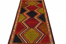 Surface texture of 2000s Persian Gabbeh rug with natural Wool and intricate pattern