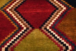 Backside of handmade 2000s Persian Gabbeh rug showing knot structure and weave density