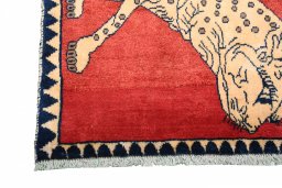 Corner detail of 2000s Persian Gabbeh rug showing border pattern and Wool pile