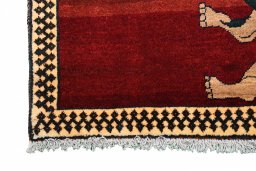 Corner detail of 2000s Persian Gabbeh rug showing border pattern and Wool pile