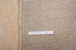 Corner detail of 2000s Persian Gabbeh rug showing border pattern and Wool pile