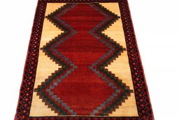 Surface texture of 2000s Persian Gabbeh rug with natural Wool and intricate pattern