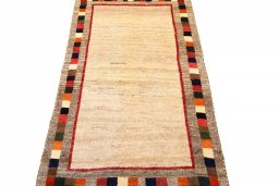 Surface texture of 2000s Persian Gabbeh rug with natural Wool and intricate pattern