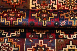 Corner detail of 2000s Persian Gabbeh rug showing border pattern and Wool pile