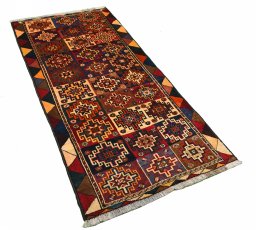 Corner detail of 2000s Persian Gabbeh rug showing border pattern and Wool pile