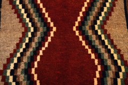 Backside of handmade 2000s Persian Gabbeh rug showing knot structure and weave density